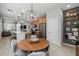 Well-lit kitchen with a large island, pendant lighting, and adjacent dining area at 1677 E Bridgeport Pkwy, Gilbert, AZ 85295