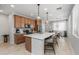 Modern kitchen featuring a large island, stainless steel appliances, and an adjacent dining area at 1677 E Bridgeport Pkwy, Gilbert, AZ 85295