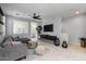 Comfortable living room featuring a gray sectional, dark wood entertainment center, and sleek design at 1677 E Bridgeport Pkwy, Gilbert, AZ 85295