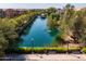 Scenic view of a community pond, fountain, and walking path at 1677 E Bridgeport Pkwy, Gilbert, AZ 85295