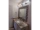 Bathroom with a decorative mirror, granite countertops, and modern fixtures at 17017 N 12Th St # 1135, Phoenix, AZ 85022