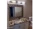 Stylish bathroom boasts granite countertops and a unique, decorative mirror at 17017 N 12Th St # 1135, Phoenix, AZ 85022