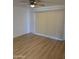 Bright living room featuring wood floors, a ceiling fan, and sliding door with vertical blinds at 17017 N 12Th St # 1135, Phoenix, AZ 85022