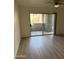 Bright living room featuring wood floors and sliding doors leading to an outdoor space at 17017 N 12Th St # 1135, Phoenix, AZ 85022