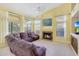 Inviting living room with a stone fireplace, a large window, and comfortable leather furniture at 17036 N 43Rd Pl, Phoenix, AZ 85032