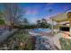 Beautiful backyard pool area with lush landscaping, a covered patio, and stone accents at 17036 N 43Rd Pl, Phoenix, AZ 85032