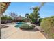 Backyard oasis with a sparkling pool, lush landscaping, and a rock waterfall feature at 17036 N 43Rd Pl, Phoenix, AZ 85032