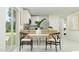 Bright dining area featuring a modern table, stylish chairs, and natural light from the sliding glass door at 17490 N Toledo Ave, Maricopa, AZ 85138