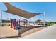 Harvester Park playground with a shade structure, picnic area, and walking path amid a residential neighborhood at 17490 N Toledo Ave, Maricopa, AZ 85138