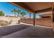 An outdoor covered back patio area with a view of the backyard and block wall at 17642 W Pershing St, Surprise, AZ 85388