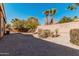 An open backyard features desert landscaping, and a block wall for privacy at 17642 W Pershing St, Surprise, AZ 85388