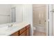 Well-lit bathroom featuring a sink vanity and a convenient shower and bathtub combination at 17642 W Pershing St, Surprise, AZ 85388