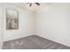 Serene bedroom featuring soft carpet, a ceiling fan, and a window providing bright natural light at 17642 W Pershing St, Surprise, AZ 85388