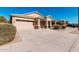 Attractive single-story home featuring a desert landscape, a covered entry, and attached two-car garage at 17642 W Pershing St, Surprise, AZ 85388