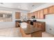 Kitchen with granite countertops, tile flooring, wood cabinets and a center island at 17642 W Pershing St, Surprise, AZ 85388