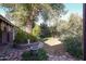 Charming backyard garden with stone-lined walkway and lush plantings at 19013 N 18Th Ave, Phoenix, AZ 85027