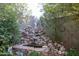 Landscaped backyard showcasing a rock water feature with a stone border at 19013 N 18Th Ave, Phoenix, AZ 85027