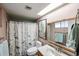 Bright bathroom featuring a shower with patterned curtain, and vanity with a framed mirror at 19013 N 18Th Ave, Phoenix, AZ 85027