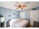 Blue bedroom with tile flooring, a ceiling fan, and closet with sliding doors at 19013 N 18Th Ave, Phoenix, AZ 85027