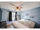 This bedroom features light blue walls and a cozy ceiling fan at 19013 N 18Th Ave, Phoenix, AZ 85027