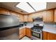 Efficient kitchen layout with stainless steel appliances, wood cabinets and ample counter space at 19013 N 18Th Ave, Phoenix, AZ 85027