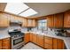 Functional kitchen with wood cabinets, stainless steel appliances and a garden window at 19013 N 18Th Ave, Phoenix, AZ 85027