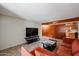 Comfortable living room with tile floors, wood paneling, a plush orange sofa and ceiling fan at 19013 N 18Th Ave, Phoenix, AZ 85027