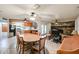 Open concept living room and kitchen features a stone fireplace and wood dining table with chairs at 19013 N 18Th Ave, Phoenix, AZ 85027