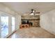 Bright living room with stone fireplace, tile flooring, and glass doors leading to the outside at 19013 N 18Th Ave, Phoenix, AZ 85027