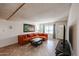 Relaxing living room featuring a modern orange couch, tile flooring, and natural light at 19013 N 18Th Ave, Phoenix, AZ 85027