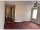 Spacious bedroom featuring a ceiling fan, neutral paint, plush carpet, and a large window offering natural light at 2016 S 66Th Ln, Phoenix, AZ 85043