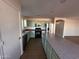 Bright kitchen featuring stainless steel appliances, light green cabinets, and an island with counter seating at 2016 S 66Th Ln, Phoenix, AZ 85043