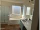 Bright main bathroom with a separate shower and a luxurious soaking tub at 2016 S 66Th Ln, Phoenix, AZ 85043