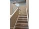 Wood and white staircase leads to the upper level with natural light at 2016 S 66Th Ln, Phoenix, AZ 85043