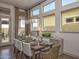 Elegant dining room with modern lighting, ample seating, and sliding door to the patio at 2038 W Union Park Dr, Phoenix, AZ 85085