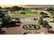 Aerial view of golf course with homes in the background and desert landscaping in the front at 21614 N 138Th Ave, Sun City West, AZ 85375