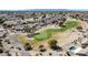 Aerial view of golf course community with homes in the background and mountains in the distance at 21614 N 138Th Ave, Sun City West, AZ 85375