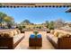 Relaxing back patio with wicker furniture and a pristine golf course view at 21614 N 138Th Ave, Sun City West, AZ 85375