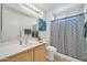 Well-lit bathroom features a sink, blue accents, and tub with curtain at 21614 N 138Th Ave, Sun City West, AZ 85375