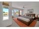 A staged bedroom with a large window that provides natural light and view to outside at 21614 N 138Th Ave, Sun City West, AZ 85375