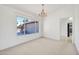 Bright dining room with a chandelier and large window offering a view of the outdoors at 21614 N 138Th Ave, Sun City West, AZ 85375