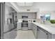 Bright kitchen with stainless steel appliances and gray cabinetry at 21614 N 138Th Ave, Sun City West, AZ 85375