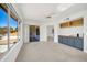 Bright living room with built-in storage and a sliding door to the patio at 21614 N 138Th Ave, Sun City West, AZ 85375