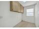 Bright storage room features upper cabinets and plenty of open space at 21614 N 138Th Ave, Sun City West, AZ 85375