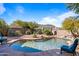 Private backyard pool oasis with a natural rock waterfall feature and desert landscaping at 2168 E Vista Bonita Dr, Phoenix, AZ 85024