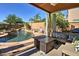 Beautiful outdoor pool with waterfall feature, covered seating area, and privacy fence at 2168 E Vista Bonita Dr, Phoenix, AZ 85024