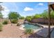 Private backyard oasis featuring a pebble tec pool, rock waterfall, and desert plants at 2168 E Vista Bonita Dr, Phoenix, AZ 85024