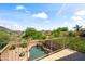 Backyard view featuring desert landscaping, mountain views, and a rock waterfall pool at 2168 E Vista Bonita Dr, Phoenix, AZ 85024