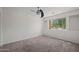 A bright bedroom with carpet flooring and a large window with outdoor views at 2168 E Vista Bonita Dr, Phoenix, AZ 85024