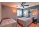 Bedroom featuring two beds, ceiling fan, and vibrant decor at 2168 E Vista Bonita Dr, Phoenix, AZ 85024